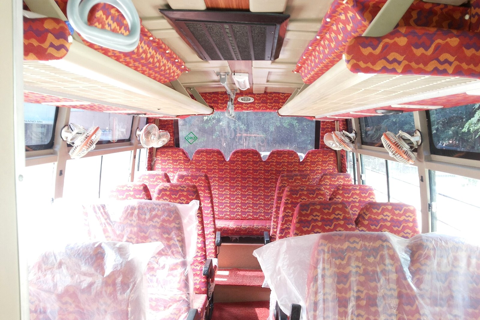 Mini coach interior with seat rows and overhead luggage racks