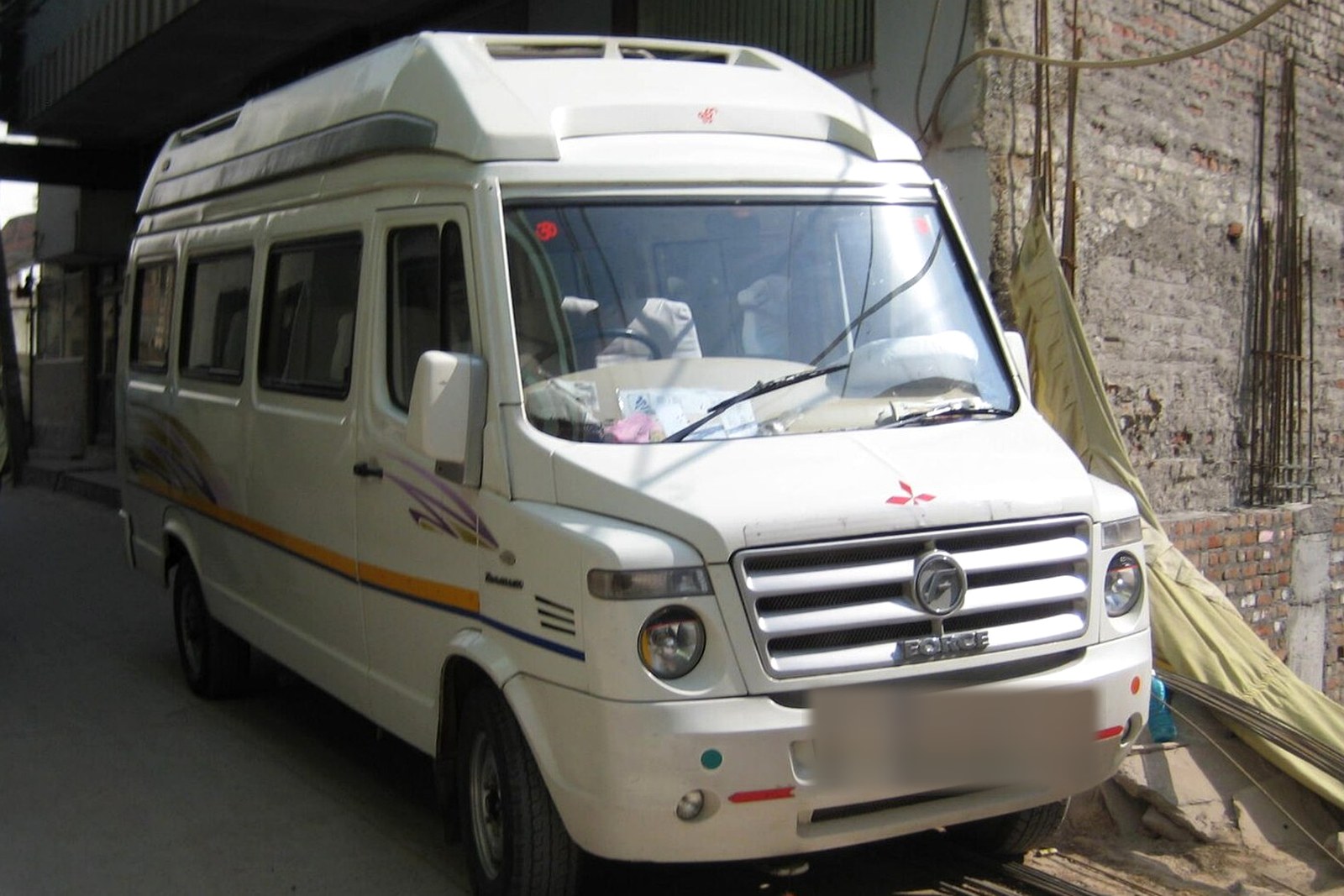 Raahi Vacation 18 seater tempo traveller, front three-quarter view