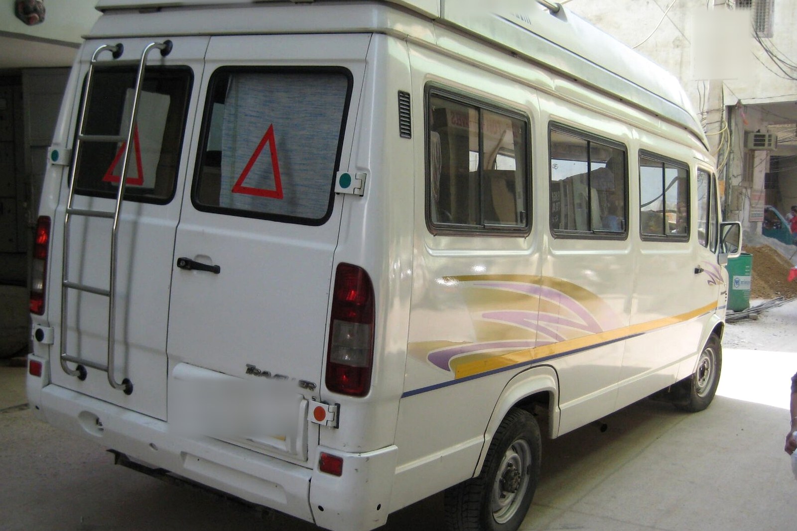 Raahi Vacation 18 seater tempo traveller, rear three-quarter view